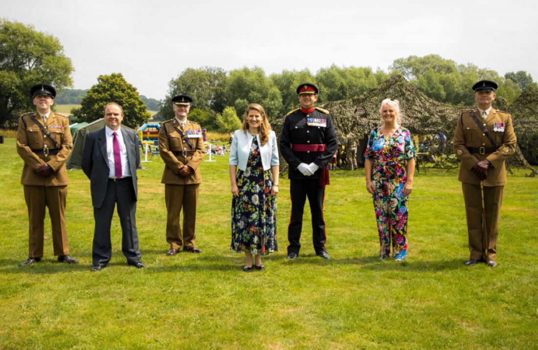 Award recipients standing with British Army officers and a Deputy Lieutenant at an outdoor military event
